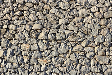 Texture of a grey granite stone wall for background