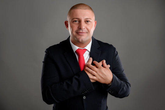 Businessman dressed in black suit Grateful happy