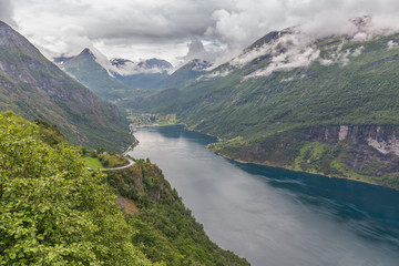 Fototapeta na wymiar Geiranger fjord, Beautiful Nature Norway. It is a 15-kilometre, 9.3 mi long branch off of the Sunnylvsfjorden, which is a branch off of the Storfjorden selective focus