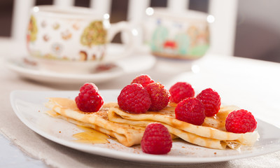 delicious  pancakes with fresh raspberries and honey