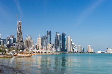 Fototapeta na wymiar Skyscrapers in the city center with water and boat foreground of Doha, Qatar 2020.