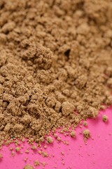 guarana powder on a pink  background.Super food. Useful product. Healthy eating concept. Natural energetic. Portion of Guarana Powder.Pile of guarana powder. 