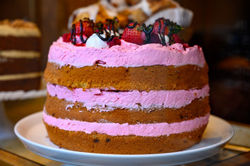 British sweet dessert biscuit cake with pink strawberry cream