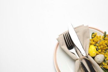 Festive Easter table setting with floral decor on white background, top view