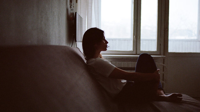 Portrait of a woman who is sitting on a sofa