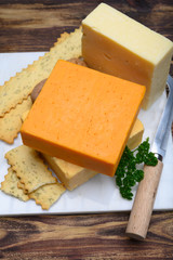 Leicestershire cheese or red leicester and mature cheddar, variety of British hard cheeses made from cow milk