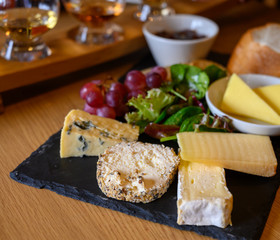 Tasting of original scottish cheese and whisky, plate with scottish cheeses and variety of Scotch...
