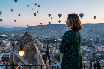 Woman soaking in a magical hot air balloon morning in Cappadocia