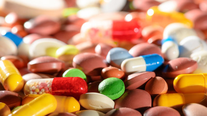 Colorful pills and drugs background. Medicinal tablets capsules pills. Selective focus