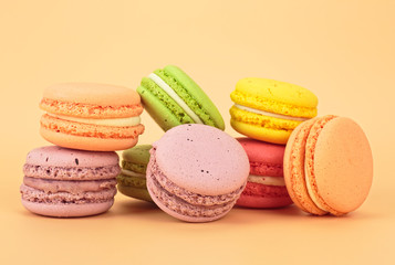 Sweet and colourful french macaroons on colored background