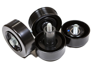 Aftermarket spare parts for car engine as idler pulley, jockey roller, gallow pulley. Kit isolated on white background