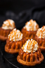 Homemade carrot cupcakes with caramel sauce and cream cheese frosting