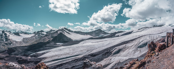 Panorama of glacier and mountains. Mount Elbrus, Caucasus, Russia. .Clouds and sky in the...