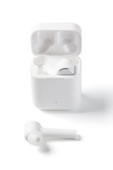  White Wireless Sport Headphones with Charging Box. Wireless in-ear Headphones for Jogging. Close Up View. Isolated on White Background.