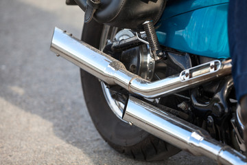 Two direct exhaust pipes on chopper motorcycle, chrome loud sound silencer