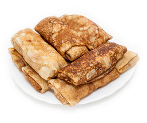 Rolled pancakes on white plate, white background