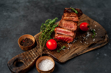 four grilled steaks with spices on a stone background. Four types of meat frying Rare, Medium, Medium Well, Well Done