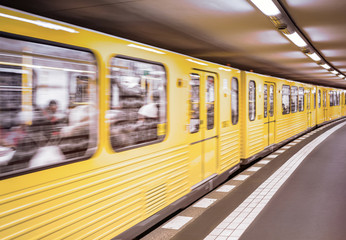 yellow subway cars go to the station