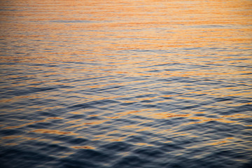 Reflection of a sunset on the water of the lake of constance