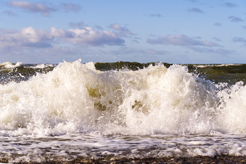 Storm at baltic sea. big waves at beach with pebbles