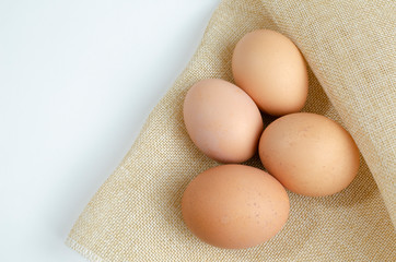 four brown chicken eggs on a dark background close-up