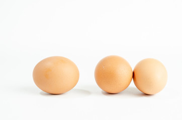 group of fresh brown chicken eggs on a white background