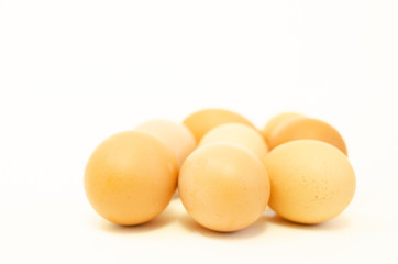 group of fresh brown chicken eggs on a white background