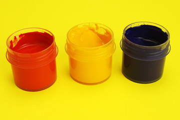 Jars of gouache on a yellow background