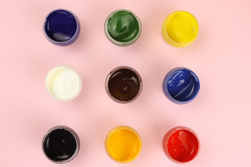 Gouache cans on a pink background