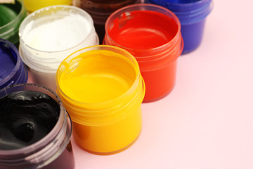 Gouache cans on a pink background