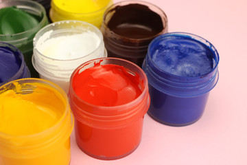 Gouache cans on a pink background
