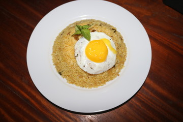 top view of yellow rice with egg omelette dish image