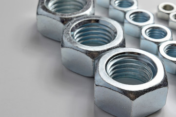 Big and small screw-nut. Concept. White background.