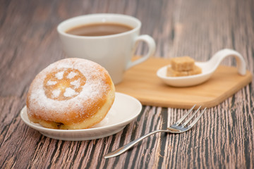 Dessert, Donuts, chocolate and strawberry circles, sugar and cream on Donuts and hot coffee cups, preparation for a break or party on the wooden table background.