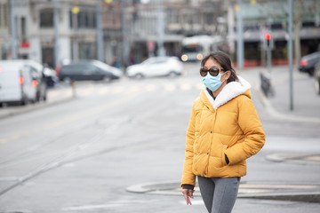 The image face of a young Asian woman wearing a mask to prevent germs, toxic fumes, and dust....