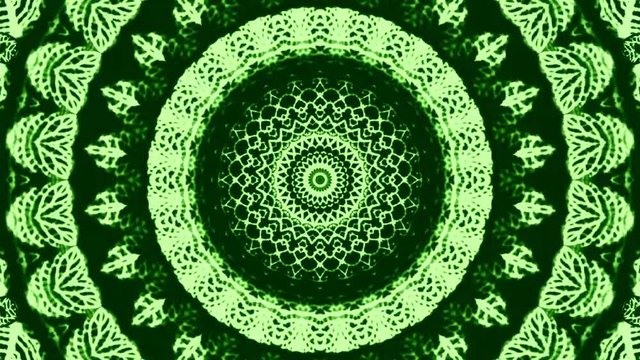 Beautiful abstract kaleidoscope that shines, a radiant light that regulates the subtle movements of the color green with a flower shape, black background
