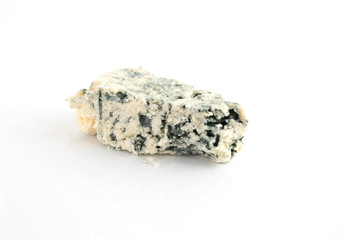 a piece of soft blue cheese with mold on a white background