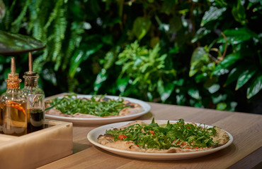 Vegan pizza with fresh arugula