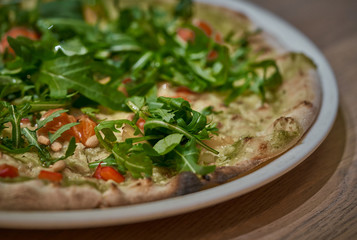 Vegan pizza with fresh arugula
