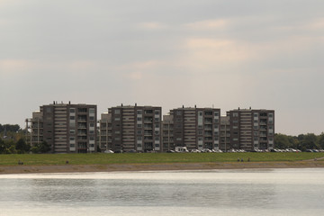 four appartment buildings behind the sea dike with a beautiful view at the westerschelde sea in the netherlands in summer