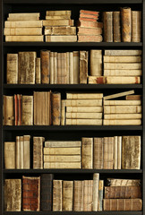antique books on old wooden shelf.