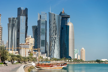 Skyscrapers in the city center with water and boat foreground of Doha, Qatar 2020.