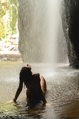 Pleased brunette female person sitting in water