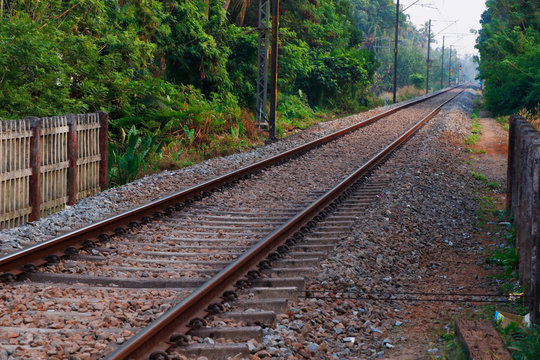 Landscape of railroad tracks in India cutting across rural countryside