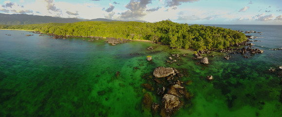 Pristine nature: Aerial drone panorama of untouched rainforest meeting the ocean / Masoala/...