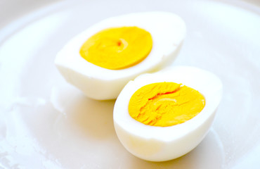 Sliced  boiled egg on white plate 