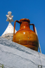An Apulian capasone, clay bowl, on a roof of a trullo in Alberobello, Bari, Puglia, Italy