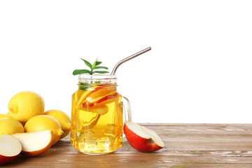 Mason jar of cold tea on table against white background