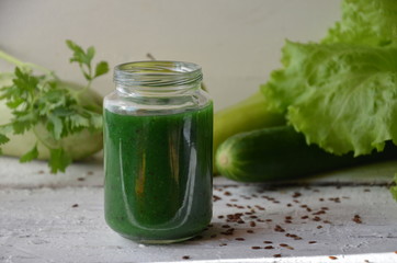 Detox diet. Green smoothie with different vegetables on white wooden background copy space. diet vegitarians healthy low calorie food. salad, greens, green apple chia or flax linen seeds