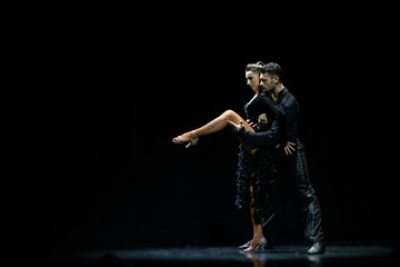 Fototapeta na wymiar Couple of dancers performing on isolated black background